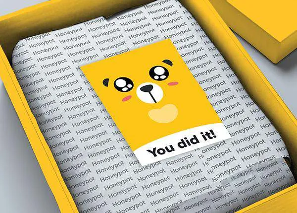 Open merch box with a 'You did it!' card