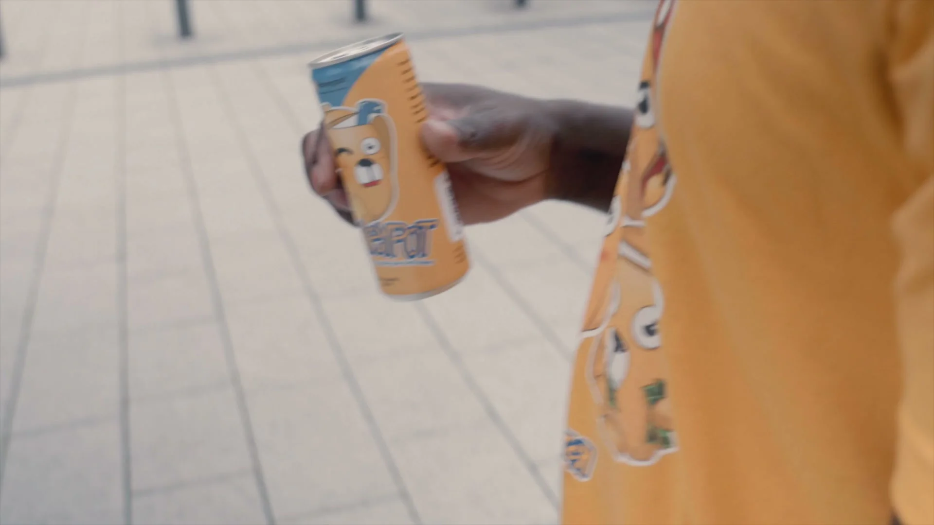 A can being handed over at the event, bear label facing out